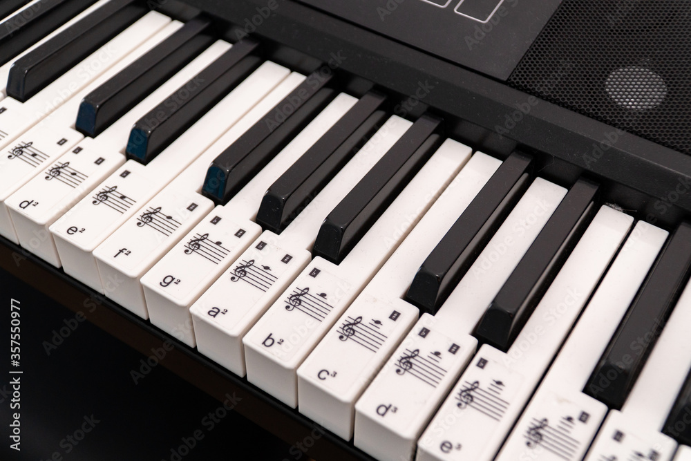 Piano side view with keys lost in the light.
