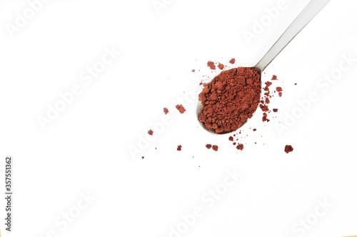 Instant coffee powder in 1 teaspoon, white background.