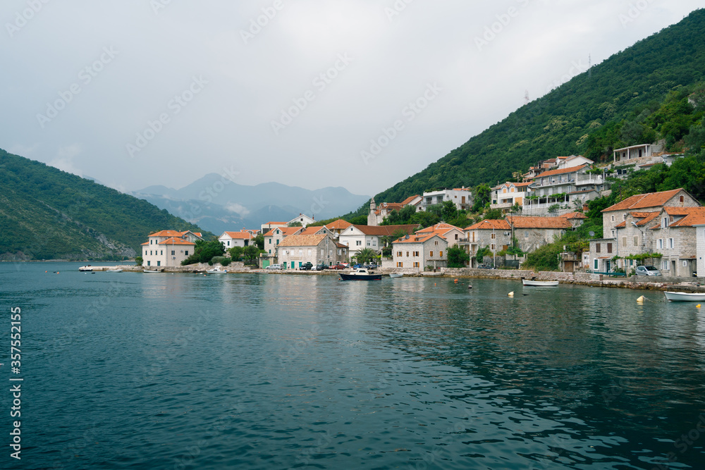 The coastline of the city of Lepetane in Montenegro, near the ferry crossing through Kotor Bay.