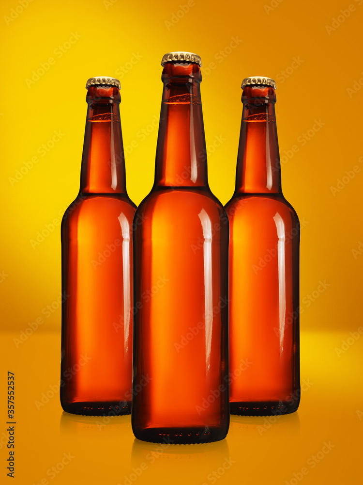 Beer bottles with long neck on yellow background mockup Beer bottles with long neck on yellow background mockup