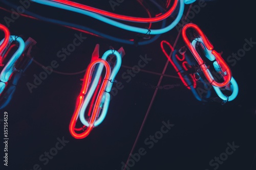 Close up of neon blue and red neon light with black background.