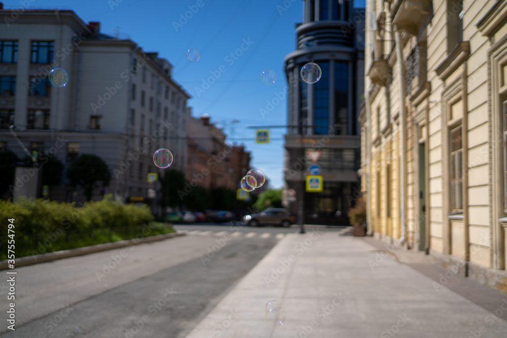 Soap bubbles in the air in the city