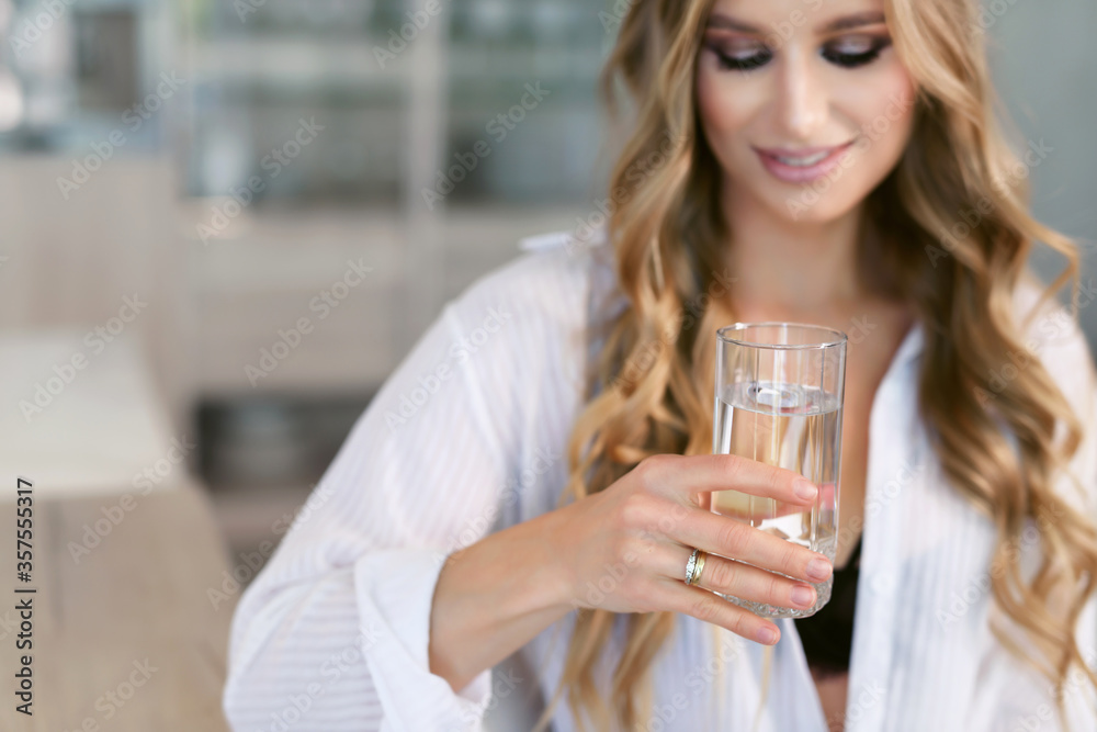 Portrait of a nutritionist. Young happy cheerful attractive woman holds a glass of clean drinking water. Healthy lifestyle concept. Portrait of a nutritionist. Young happy cheerful attractive woman holds a glass of clean drinking water. Healthy lifestyle concept.