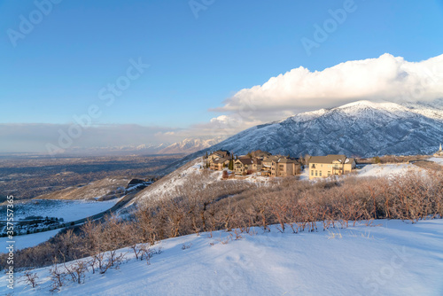 Wasatch Mountains landscape in winter with houses sitting on the snowy slope