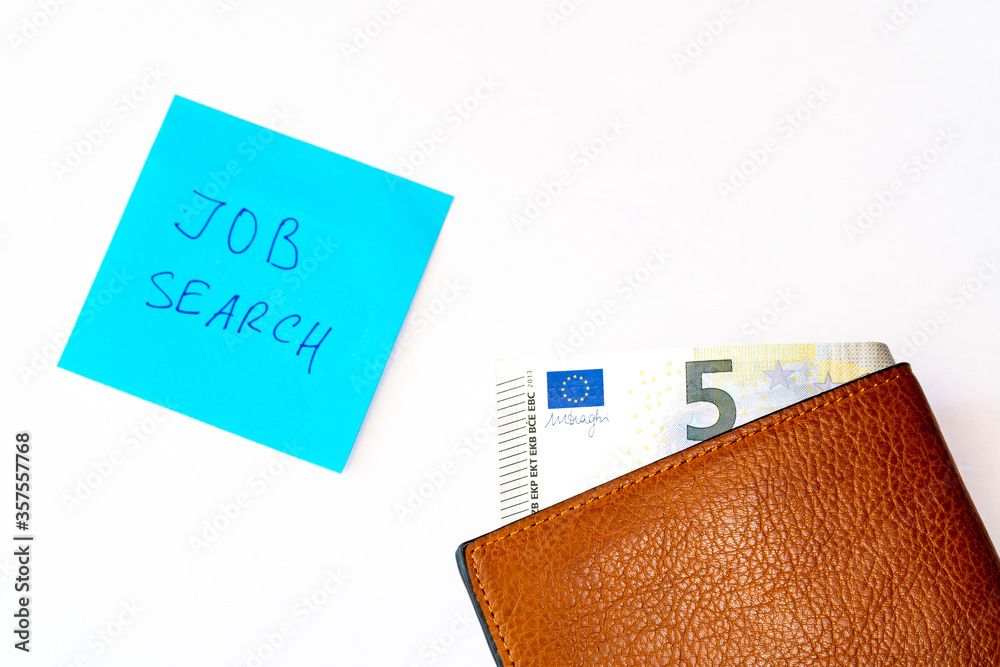 Flat lay. Notebook with job search phrase and open old shabby empty wallet purse, on white background. Searching a work, last money, poverty, unemployment, job loss concept.