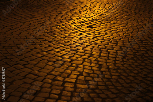 Golden night light on the street cobblestones