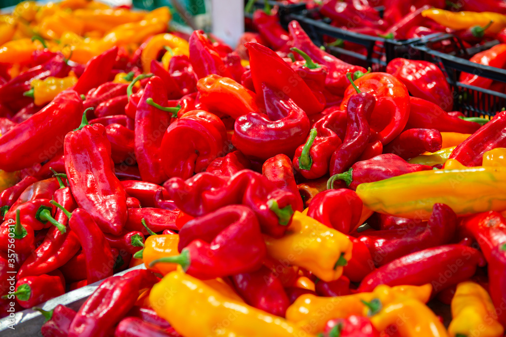 Red fresh raw ripe sweet red and yellow peppers sold in outdoor vegetables market