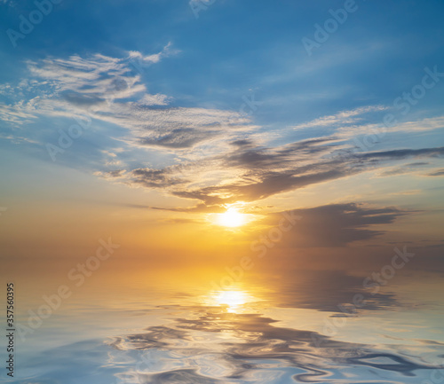 Sky background at sunset and sea water reflection.