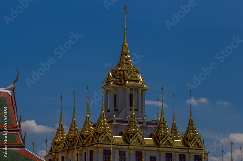 Background of tourist attractions where people come to see the beauty of the architecture of the golden pagoda in Bangkok (Wat Metal Prasat Or Wat Ratchanaddaram Worawihan) in Thailand