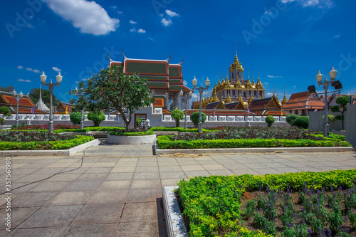 Background of tourist attractions where people come to see the beauty of the architecture of the golden pagoda in Bangkok (Wat Metal Prasat Or Wat Ratchanaddaram Worawihan) in Thailand photo
