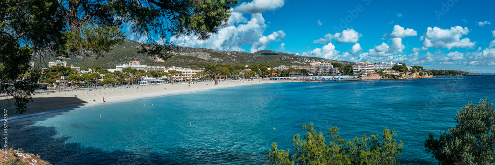 Beautiful sunny view of popular beach in Majorca, with the clean and blue water, in Balearic Islands, Spain