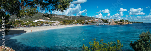 Beautiful sunny view of popular beach in Majorca, with the clean and blue water, in Balearic Islands, Spain