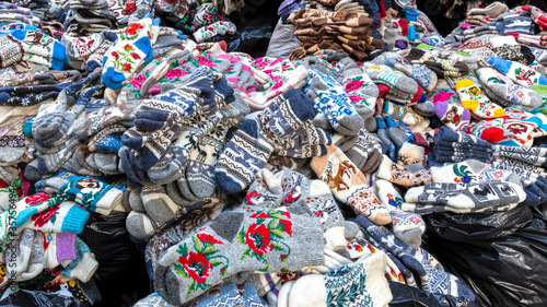Large piles of woolen products in the clothing market. © Victor