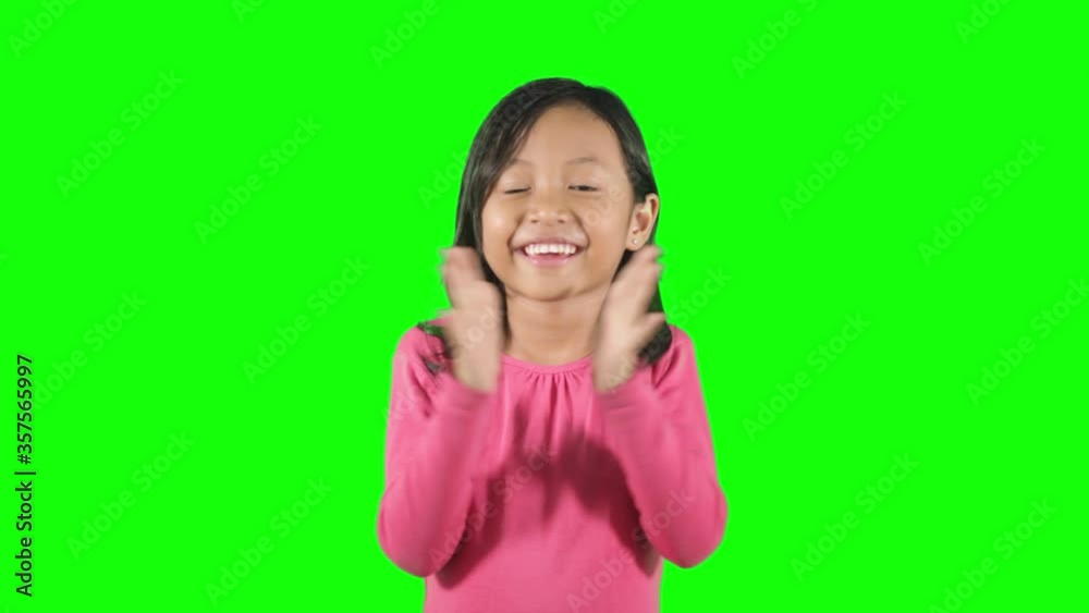 Happy little girl clapping hands in the studio Happy little girl clapping hands in the studio