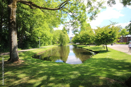 Sky and trees are reflecting on the water surface in NIeuwerkerk aan den IJssel in the Netherlands.