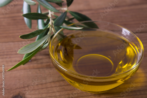 container of extra olive oil on wood