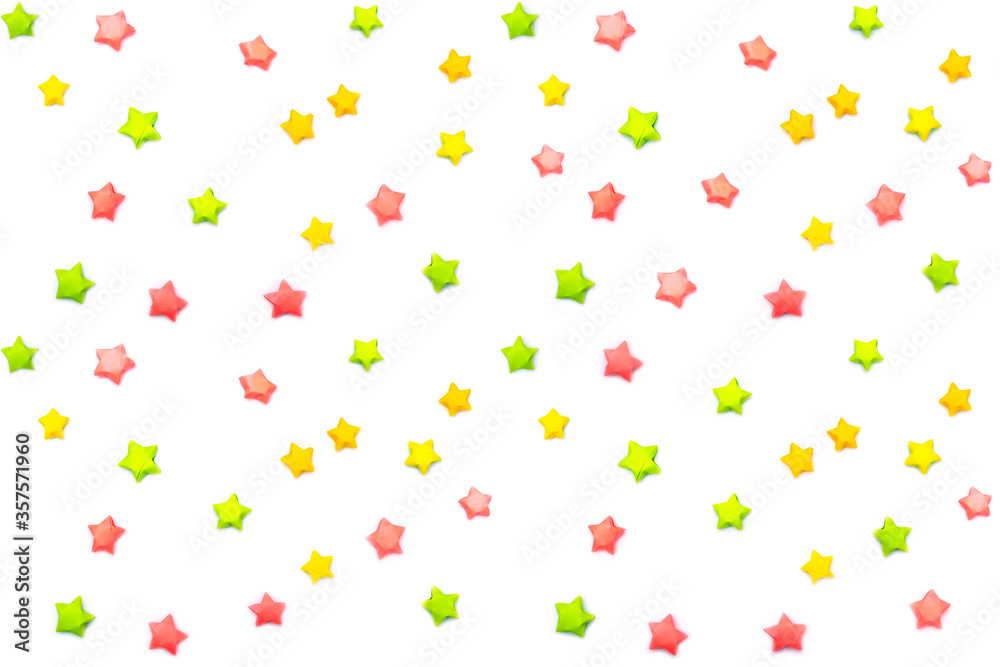 Seamless white background with multi-colored paper stars. Children's pattern for printing on fabrics, covers or wrappers.