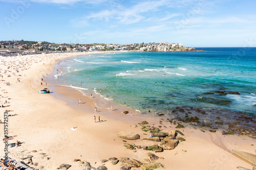 Sydney, NSW, Australia; March 2020: Bondi beach, famous urban bay in the city of Sydney, Australia. People sun bathing in summer. Turquoise water. Sydney, Australia