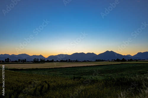 View Of Field Against Clear Sky During Sunset, In Summer, Alps.
