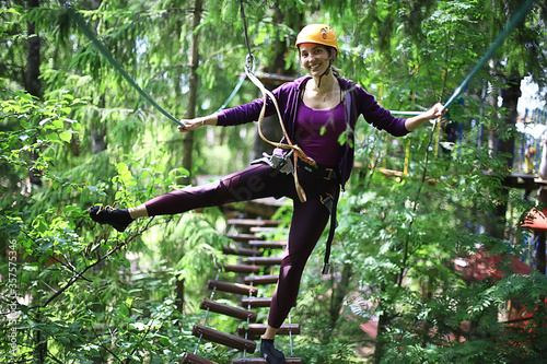 extreme vacation, girl in a yellow helmet rope park active holidays in the forest