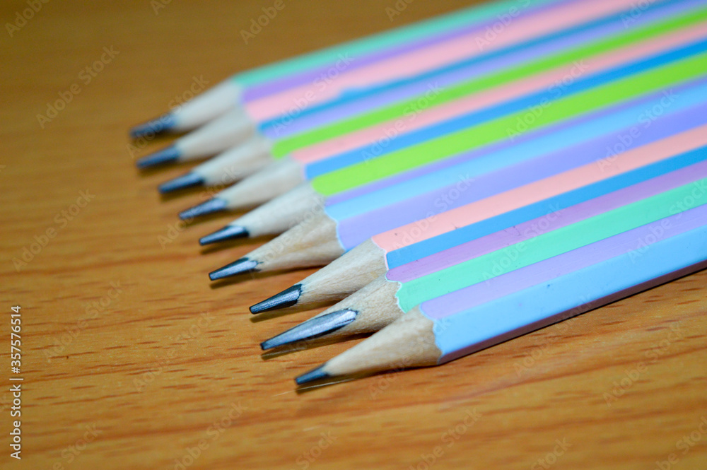 colored pencils on wooden background colored pencils on wooden background
