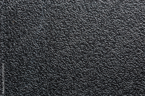 flat black rugged plastic or rubber surface with decorative bumpy finish photo