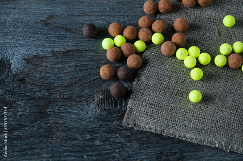 Fishing lures boilies on an old wooden background, preparing for fishing photo