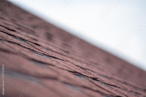 Close up view on asphalt roofing shingles background.
