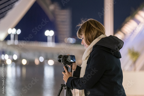 woman traveler landscape photography with mirrorless camera travel night photo with tripod to avoid shake