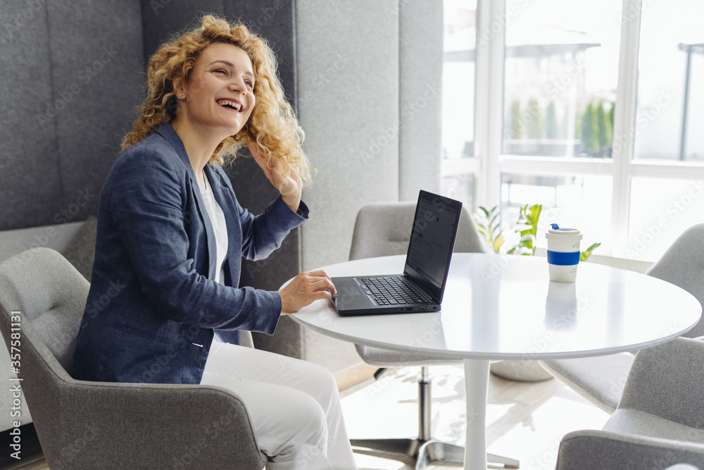 Obraz premium Portrait of smiling millennial businesswoman holding documents looking at camera, headshot of happy woman worker or female ceo posing with paperwork making picture at corporate close up photoshoot.