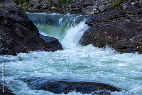 Close up on a waterfall with greenish clear water in Norway