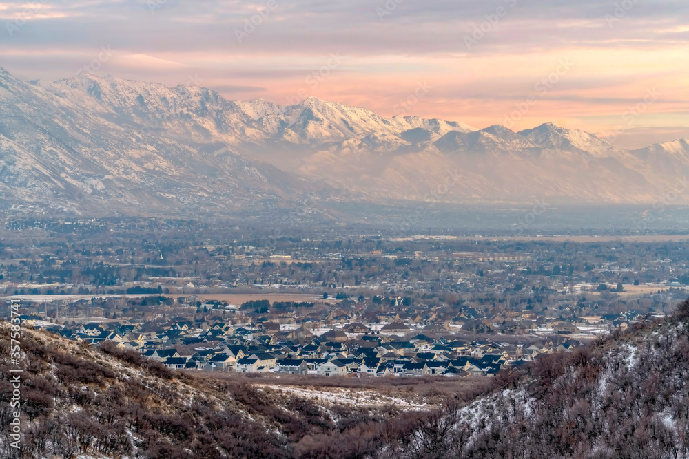 Stunning Wasatch Mountains and Utah Valley with houses dusted with winter snow