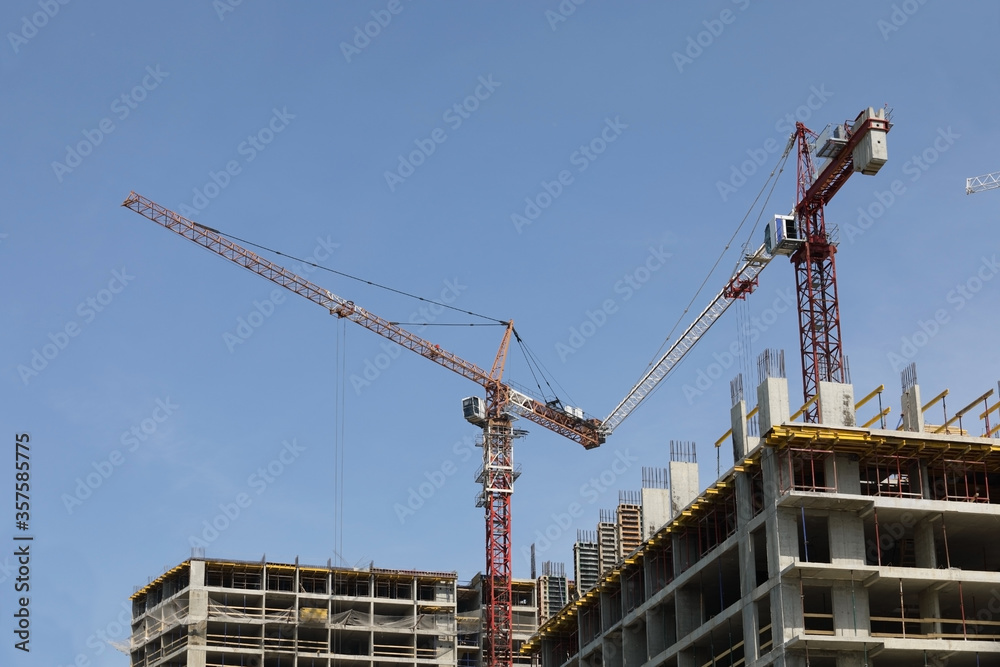 Working construction crane on a background of clear blue sky