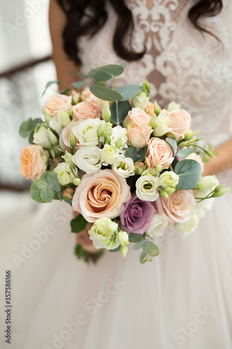 Wedding bouquet of colorful roses in the hands of the bride.