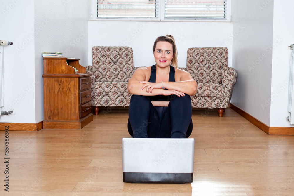 Modern life. Woman exercising at home using video lessons Modern life. Woman exercising at home using video lessons