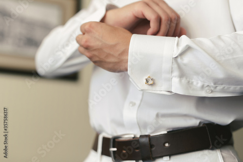 Men wear a shirt and cufflinks