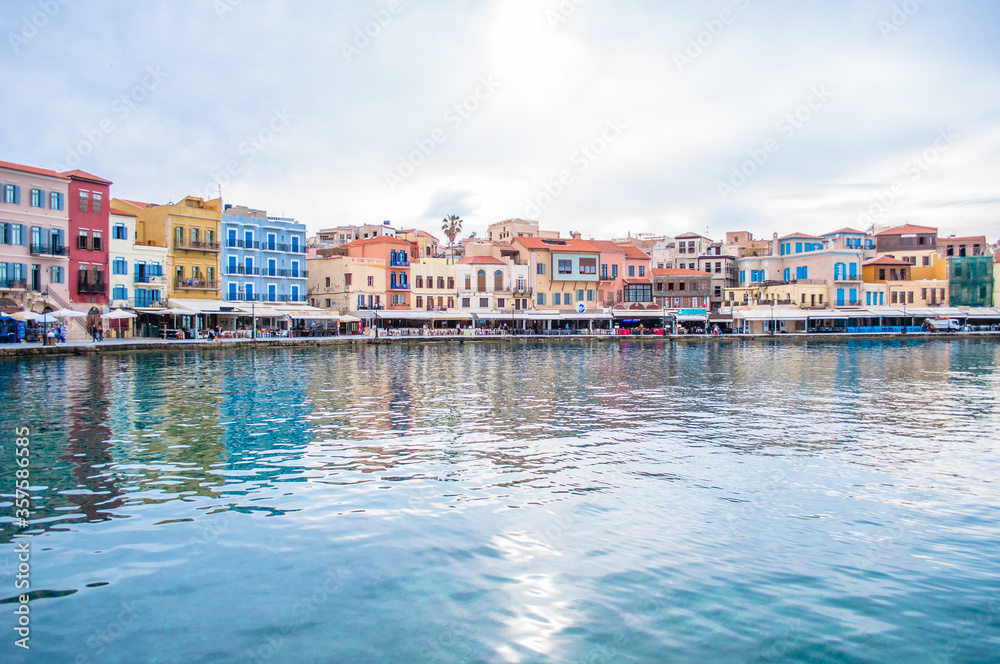Crete island of Greece, Chania bay with old town view. Cloudy day and colorful buildings, architecture. 