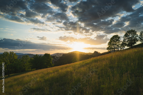 Hügel in Landschaft bei Sonnenuntergang und wolkigem Himmel in Rynartice, Sächsische Schweiz photo