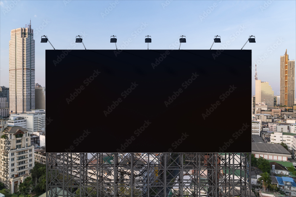 Blank black road billboard with Bangkok cityscape background at day time. Street advertising poster, mock up, 3D rendering. Front view. The concept of marketing communication to promote or sell idea.