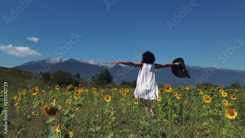 Wallpaper Mural Summer girl happy in sunflower flower field run, jump, rotate in slow motion with arms raised up Torontodigital.ca