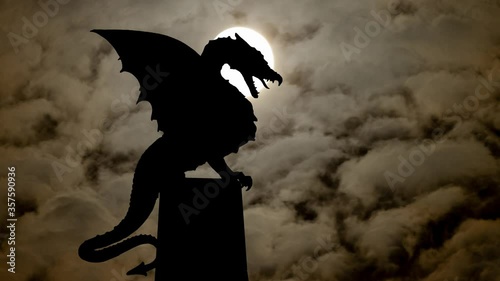Dark Silhouette of Sculpture of Dragon in Zmajski Most Bridge, Ljubljana, Slovenia photo