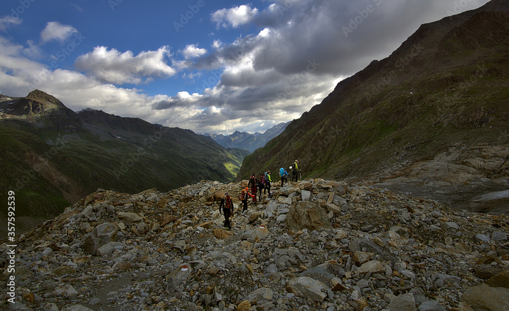 Mountain trekking group in the austrian alps on their way to Taschachferner