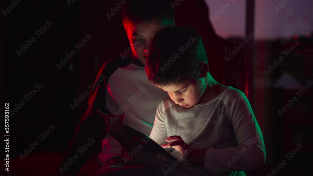 Cute brothers watching cartoon on tablet together Cute brothers watching cartoon on tablet together
