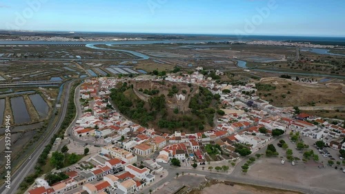 Aerial Drone View of Castro Marim Medieval Castle (Portugal), surrounded by small houses and salt pans. Guadiana River and Spain frontier in the Background