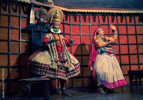 Kochi, India - March 15, 2014: An Indian classical dance form named Kathakali artists tells Indian mythological stories through numerous gestures techniques and emotions in front of European tourists.
