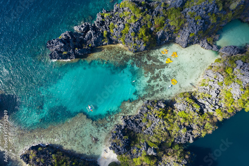 View from above, stunning aerial view of the Big Lagoon and the Small Lagoon, two beautiful bays of crystal clear water surrounded by rocky cliffs. Bacuit Bay, El Nido, Palawan, Philippines. © Travel Wild