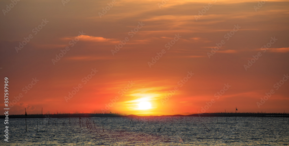 Beautiful sunset orange sky over fisherman village