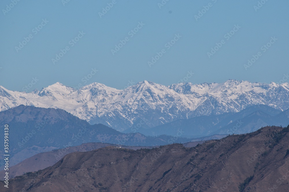 snow covered himalayan mountain peaks in winter