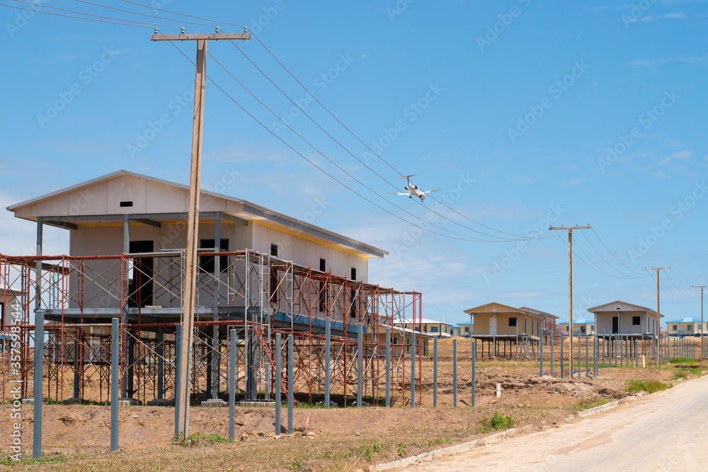 Papua New Guinea, Port Moresby, 7 Mile Kennedy Estate. Chinese builders manufacture new houses, fast building construction.  New houses for local community, Chinese project. 