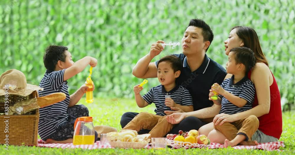 Parents and their twin sons blowing soap bubbles Parents and their twin sons blowing soap bubbles